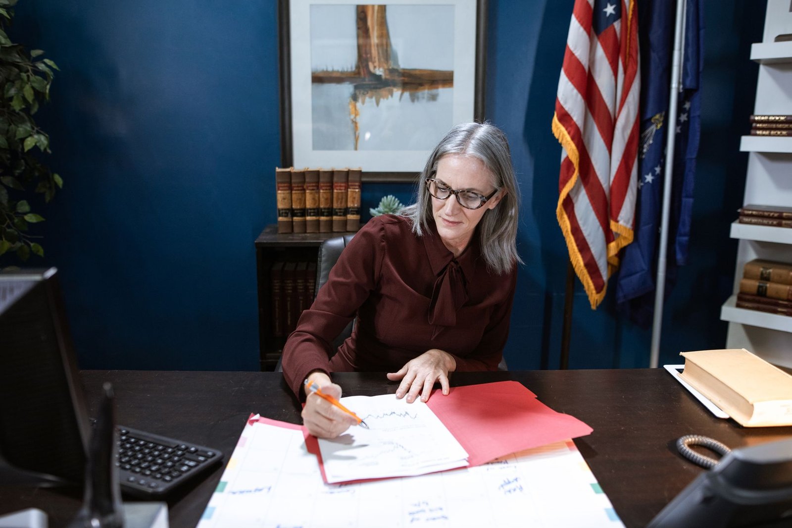 Older veteran discussing VA copay exemptions with a benefits counselor across a desk