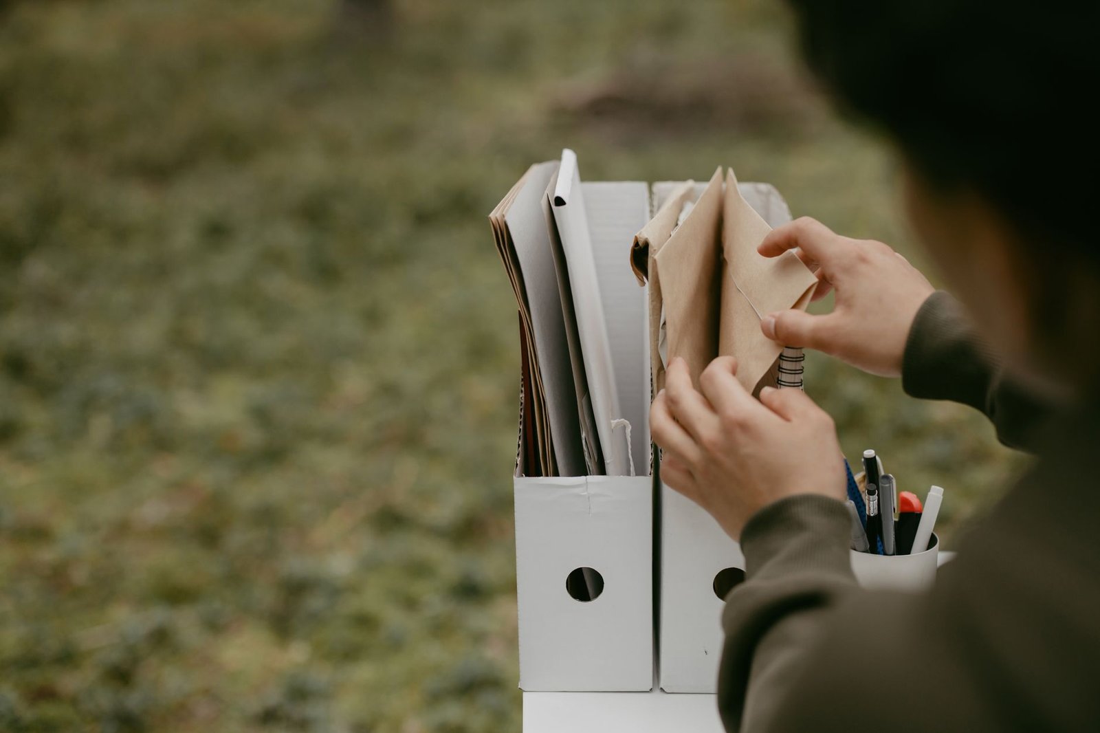 Hands sorting service records and paperwork for a VA disability claim