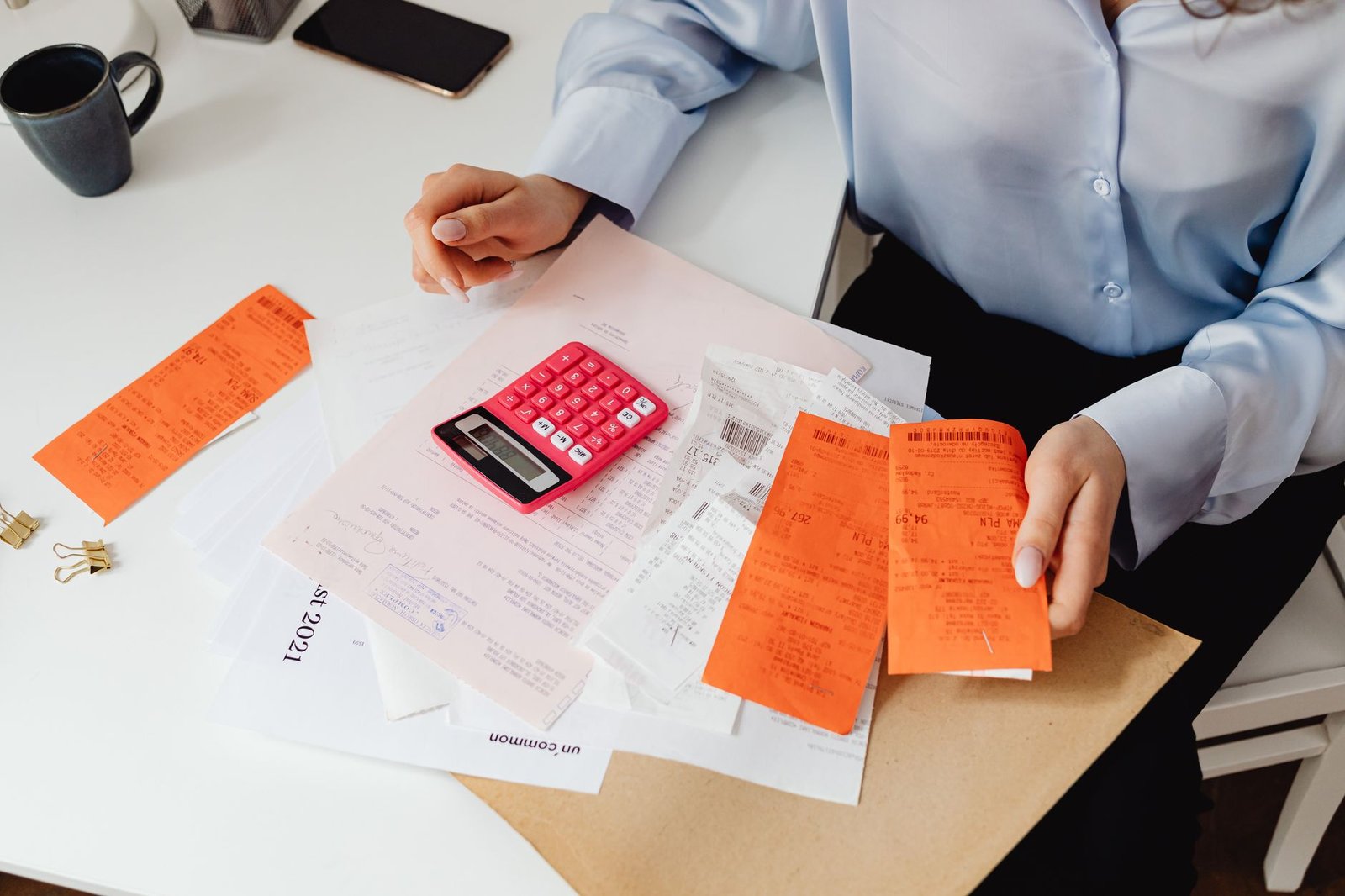 Hands reviewing paperwork and bills while requesting VA copay exemptions