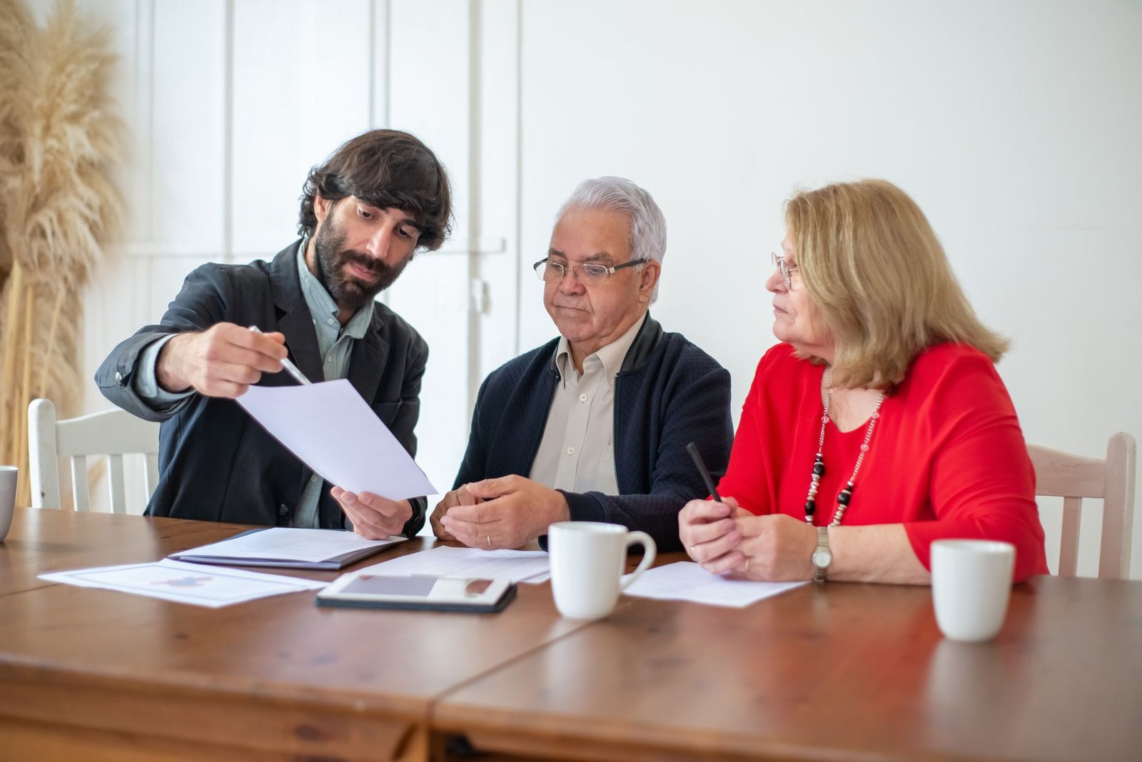 Veteran and spouse reviewing asbestos exposure claim records with a benefits advisor