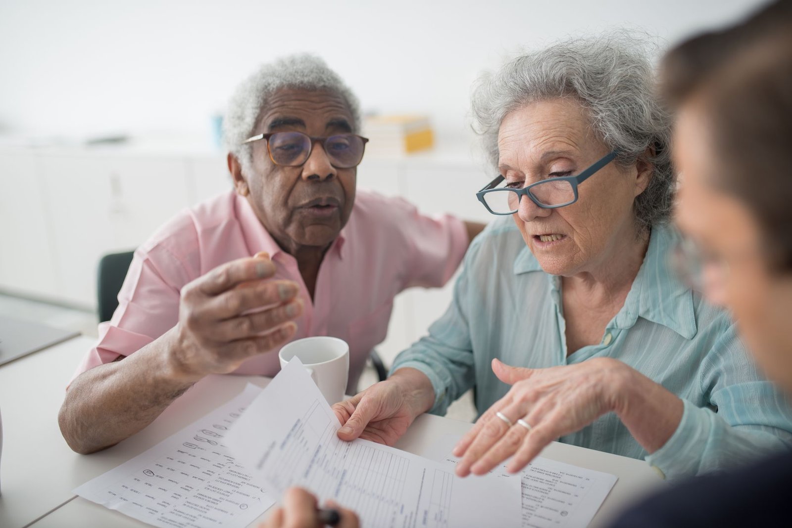 Guard veteran reviewing National Guard asbestos exposure benefits paperwork with an advisor