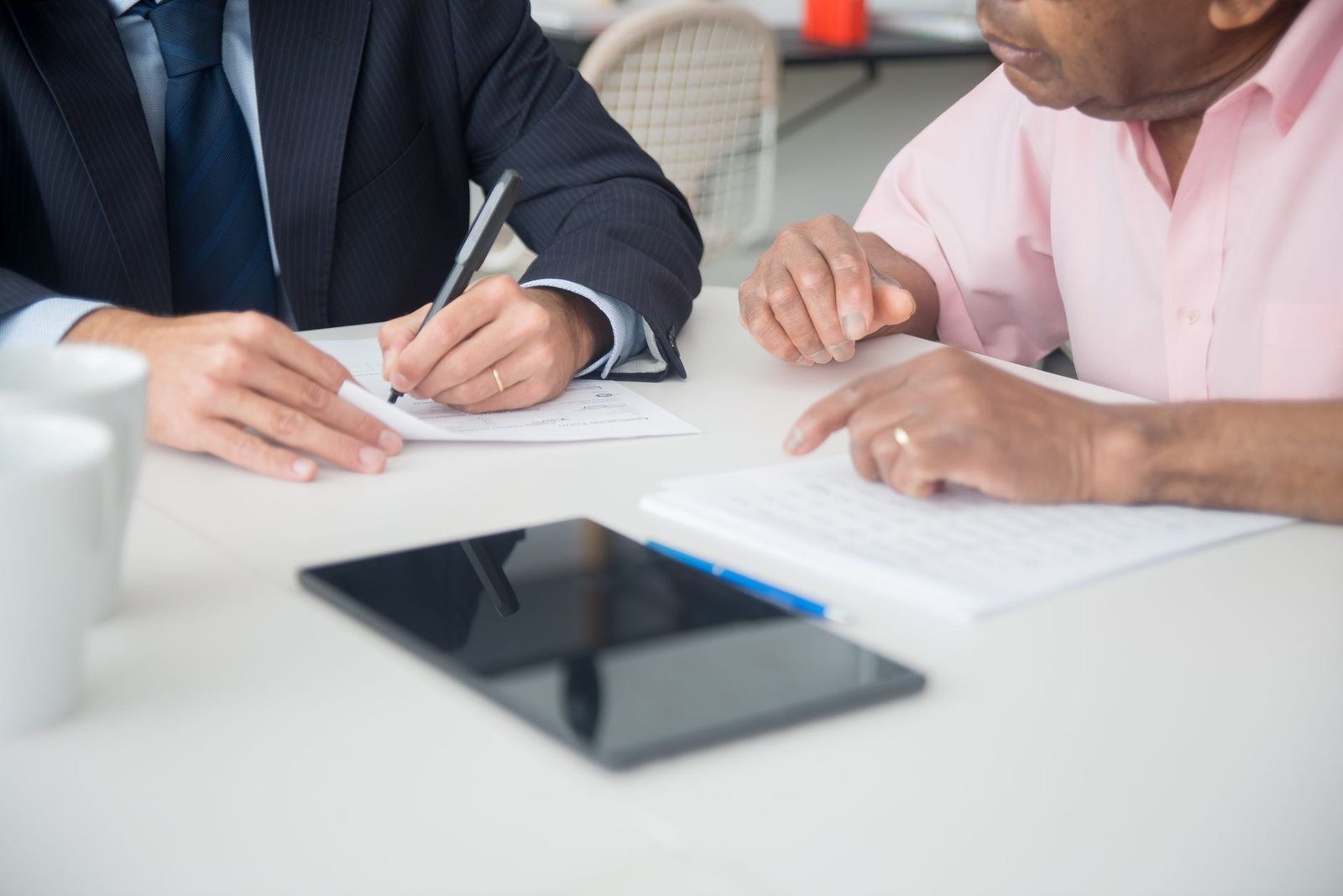 Coast Guard veteran discussing asbestos exposure benefits paperwork with an advisor