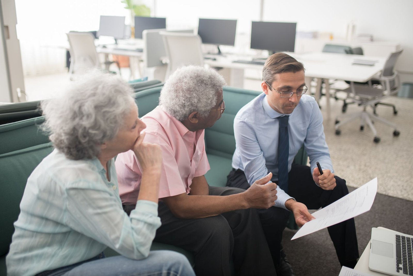 Veteran reviewing military service records with a benefits counselor across a desk